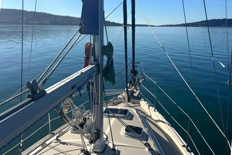 Slide: The Image of 2002 Island Packet 350 sailboat on calm water, clear sky, scenic view. - 6