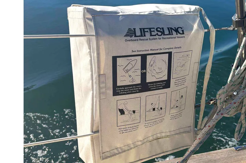 Slide: The Image of Lifesling rescue system on 2002 Island Packet 350 sailboat, with safety instructions visible. - 25