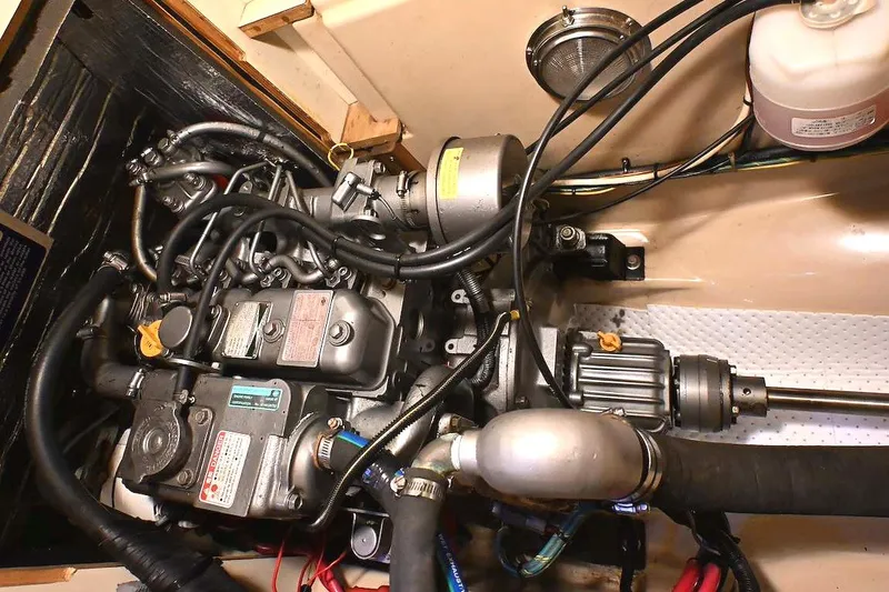 Slide: The Image of Engine compartment of a 2002 Island Packet 350 sailboat, showcasing detailed mechanical components. - 78