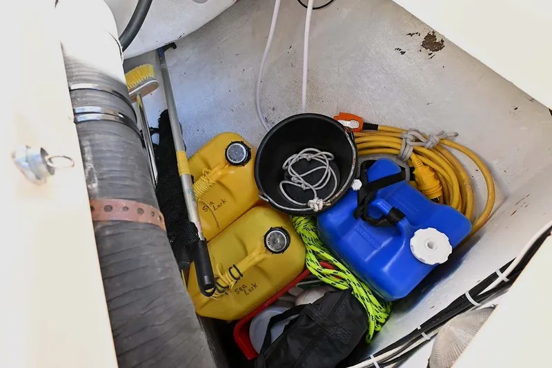 Slide: The Image of Storage compartment on a 2002 Island Packet 350 sailboat with fuel cans and equipment. - 86