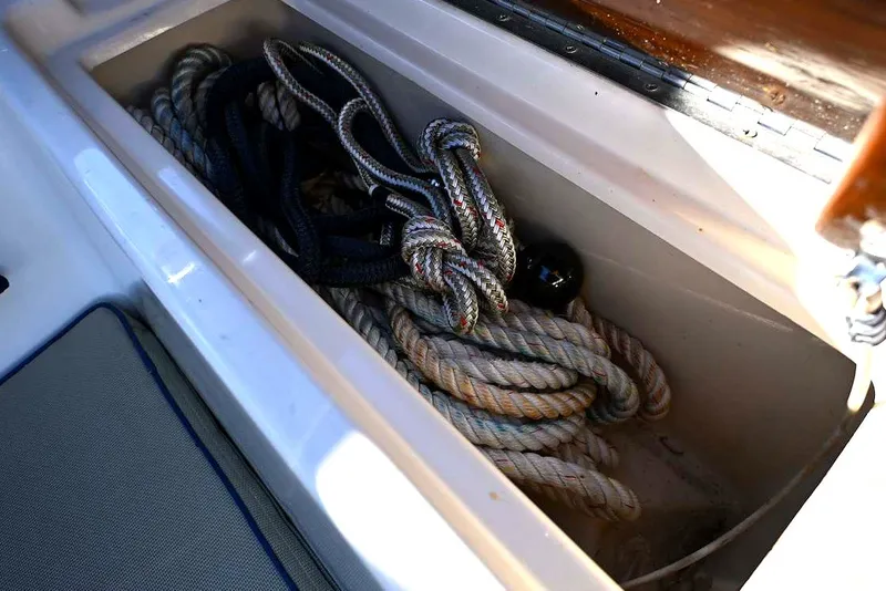 Slide: The Image of Coiled ropes in storage compartment of 2002 Island Packet 350 sailboat. - 84