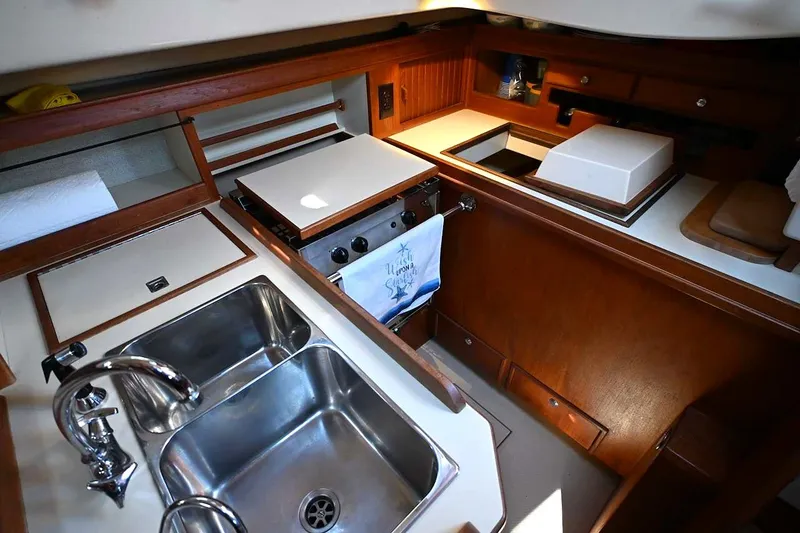 Slide: The Image of Interior of 2002 Island Packet 350 yacht kitchen with sink and stove. - 52