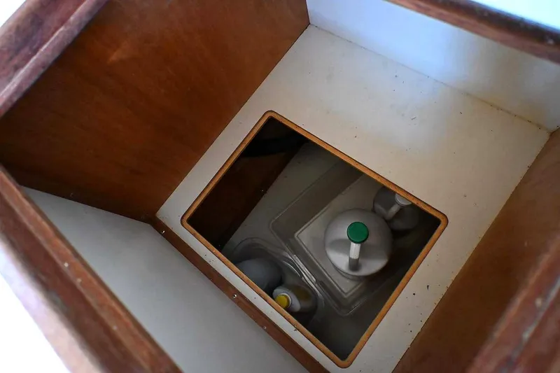 Slide: The Image of Storage compartment on a 2002 Island Packet 350 sailboat, featuring wooden interior. - 57