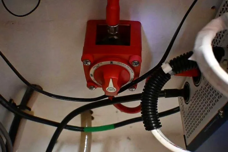 Slide: The Image of Red electrical switch in a 2002 Island Packet 350 boat's engine compartment. - 69