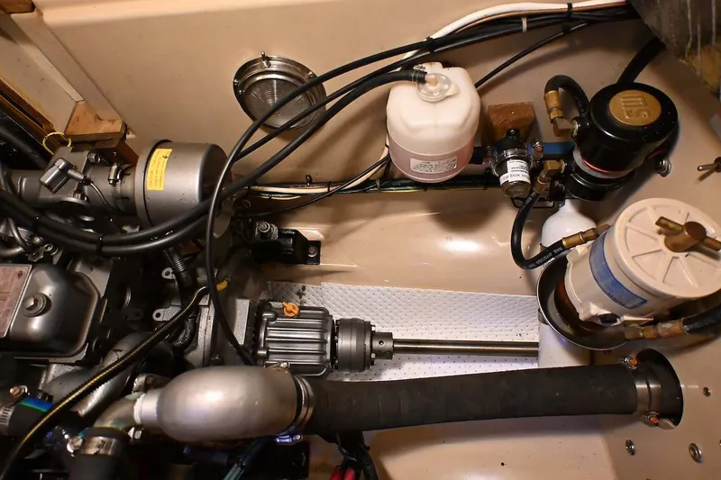 Slide: The Image of Engine compartment of a 2002 Island Packet 350 sailboat, showcasing mechanical components and wiring. - 79