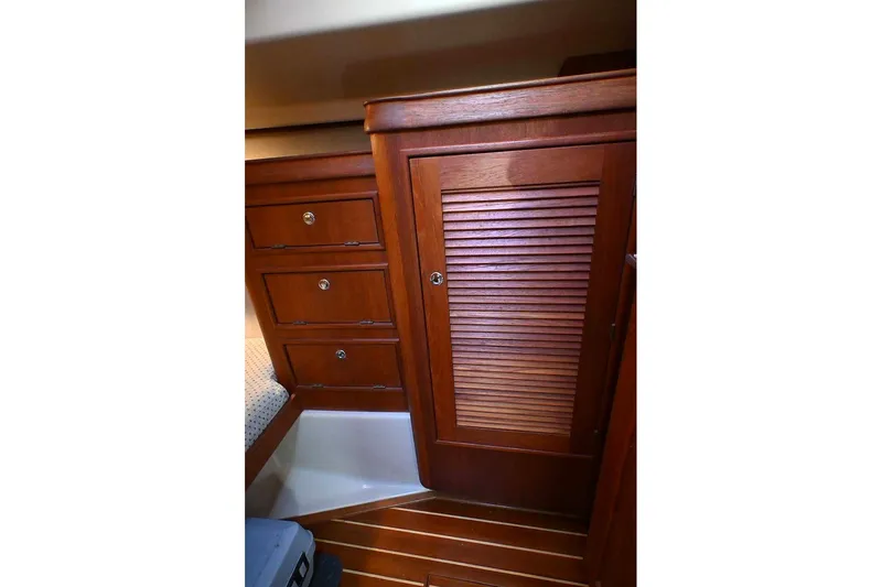 Slide: The Image of Interior of 2002 Island Packet 350 sailboat with wooden cabinetry and drawers. - 61