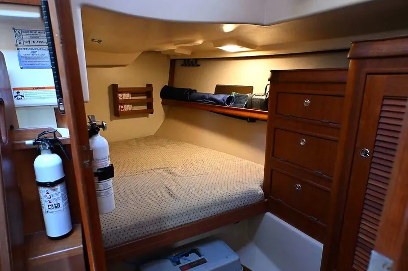 Slide: The Image of Cozy cabin interior of 2002 Island Packet 350 sailboat with bed, storage, and fire extinguishers. - 60