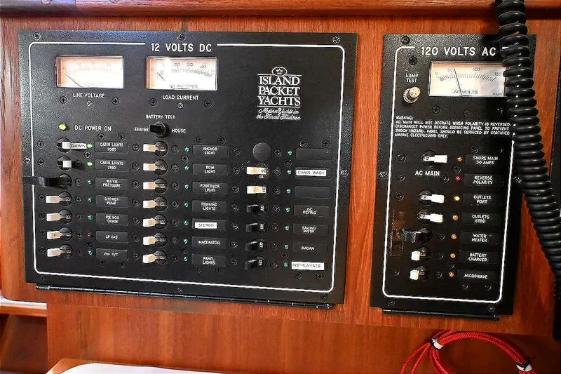 Slide: The Image of Electrical control panel on a 2002 Island Packet 350 yacht, featuring 12V DC and 120V AC systems. - 37