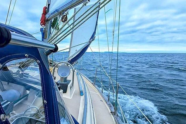 Slide: The Image of Sailing on a 2002 Island Packet 350 yacht in open sea under cloudy skies. - 27