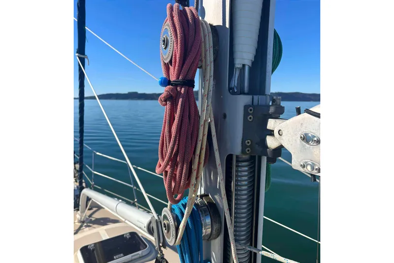 Slide: The Image of Close-up of 2002 Island Packet 350 sailboat rigging against a calm sea backdrop. - 12