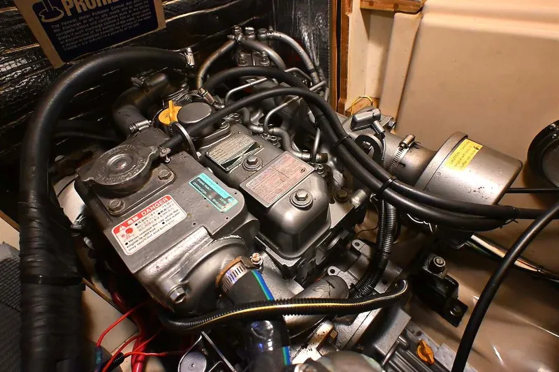 Slide: The Image of Engine compartment of a 2002 Island Packet 350 sailboat, showcasing mechanical components and wiring. - 77