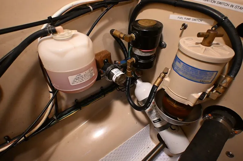 Slide: The Image of Engine compartment of a 2002 Island Packet 350 sailboat, showing fuel pump and filter system. - 80
