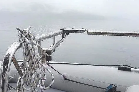 Slide: The Image of Sailboat deck view with ropes, Island Packet 350, 2002 model, misty waterscape. - 29