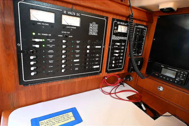 Slide: The Image of Electrical control panel on a 2002 Island Packet 350 yacht, featuring various switches and meters. - 36