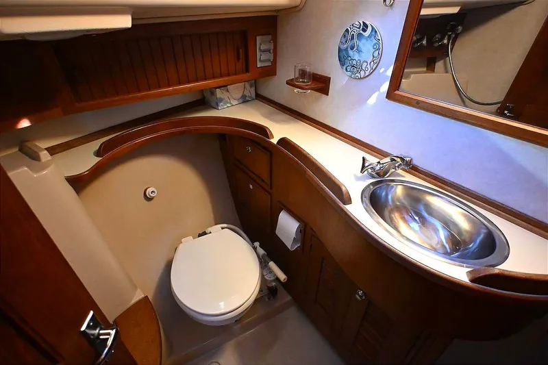 Slide: The Image of Luxurious 2002 Island Packet 350 yacht bathroom with wooden cabinetry and stainless steel sink. - 45