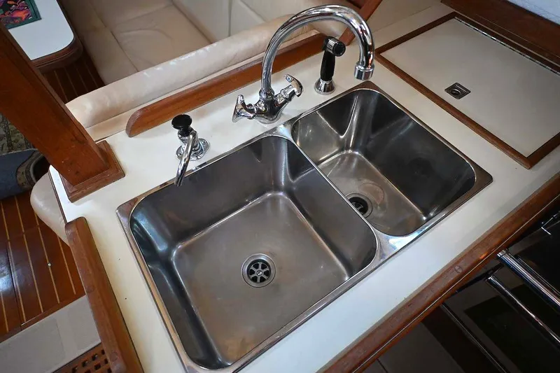 Slide: The Image of 2002 Island Packet 350 yacht kitchen with dual stainless steel sinks and faucet. - 55
