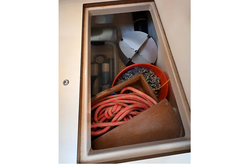 Slide: The Image of Storage compartment on a 2002 Island Packet 350 sailboat with ropes and equipment. - 72