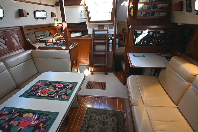 Slide: The Image of Interior of 2002 Island Packet 350 sailboat with cozy seating and wooden finishes. - 31