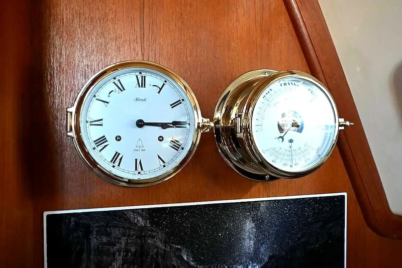 Slide: The Image of Brass clock and barometer on 2002 Island Packet 350 yacht interior. - 34
