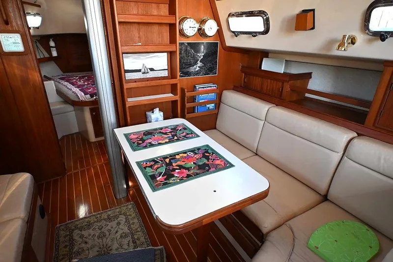 Slide: The Image of Interior of 2002 Island Packet 350 sailboat with cozy seating and wooden accents. - 33