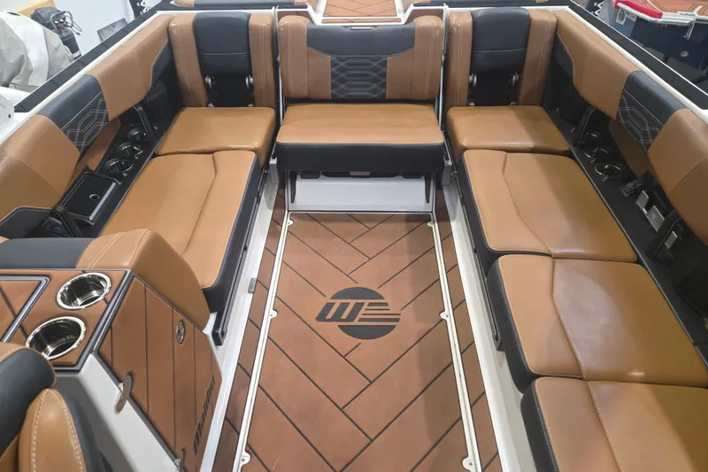 Slide: The Image of Luxurious interior of 2022 Malibu Wakesetter 25 LSV with tan leather seating and cup holders. - 13