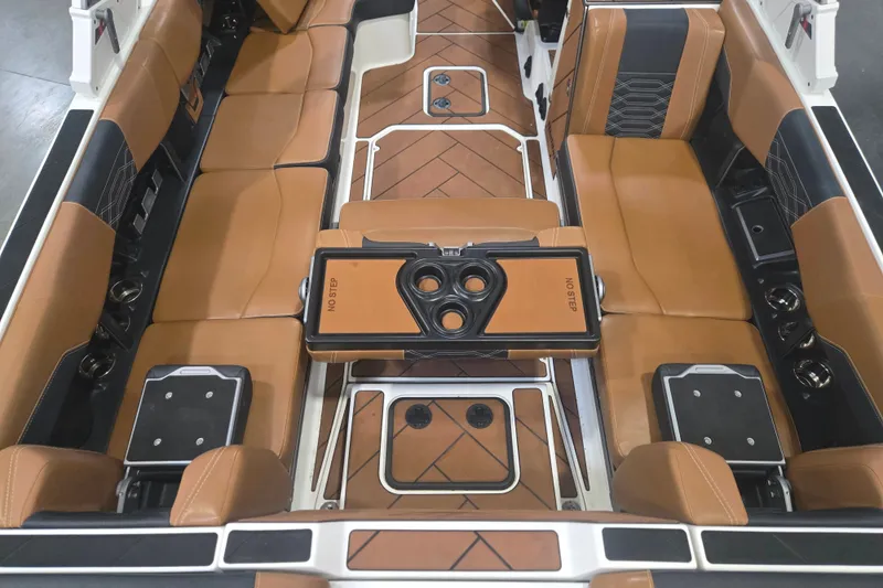 Slide: The Image of 2022 Malibu Wakesetter 25 LSV interior with tan leather seating and cup holders. - 18