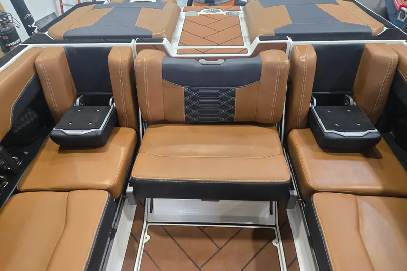Slide: The Image of Luxurious interior seating of 2022 Malibu Wakesetter 25 LSV with tan and black upholstery. - 16