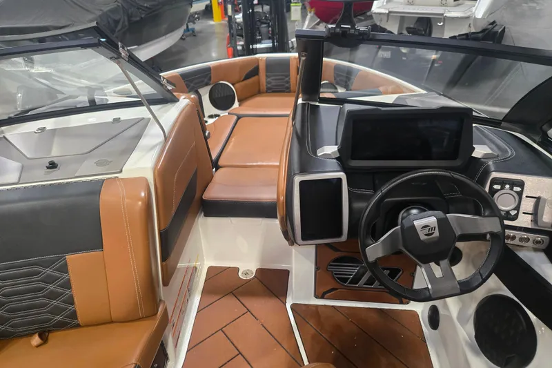 Slide: The Image of Interior of 2022 Malibu Wakesetter 25 LSV boat with brown and black seating. - 19