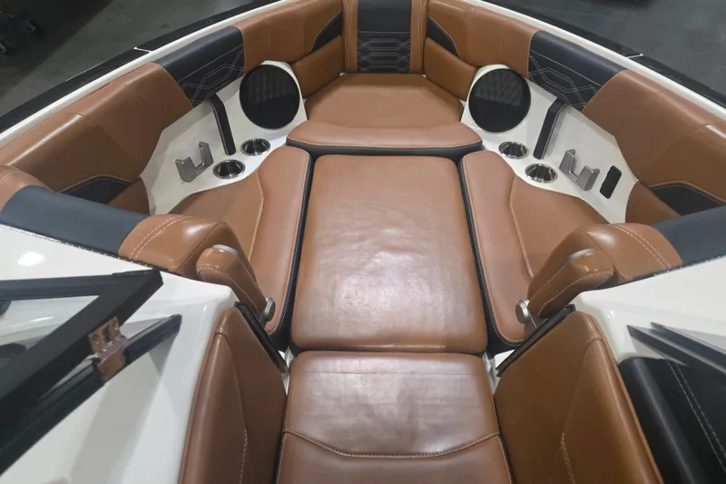 Slide: The Image of 2022 Malibu Wakesetter 25 LSV interior with luxurious brown leather seating and cup holders. - 15