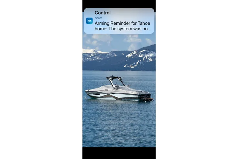Slide: The Image of 2022 Malibu Wakesetter 25 LSV on a serene lake with snowy mountains in the background. - 22