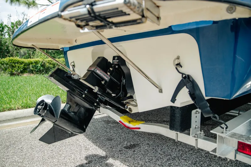 Slide: The Image of 2019 Bayliner 215 Deck Boat with MerCruiser engine, parked on a trailer. - 7