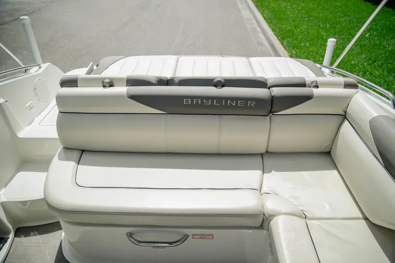 Slide: The Image of 2019 Bayliner 215 Deck Boat with comfortable seating and sleek design. - 9