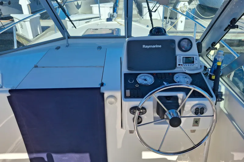 Slide: The Image of Helm of 2005 Back Cove 26 boat with Raymarine navigation system. - 10