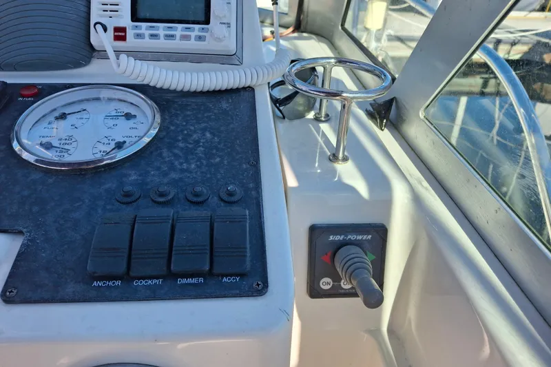 Slide: The Image of Control panel of a 2005 Back Cove 26 boat, featuring gauges and switches. - 11