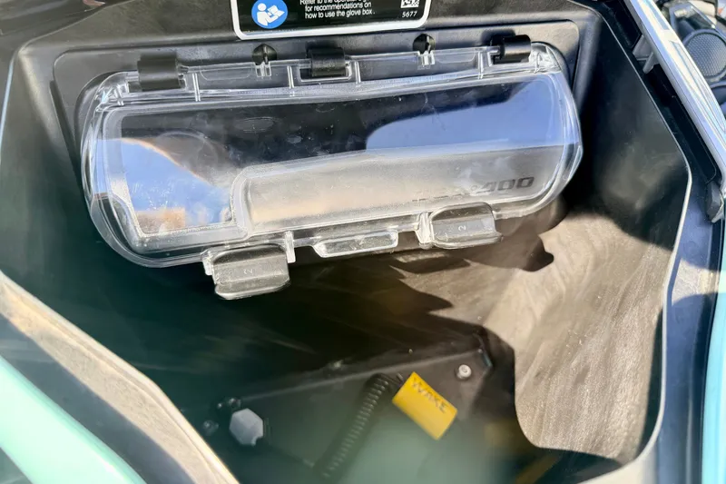 Slide: The Image of 2024 Seadoo GTR-X 300 & WAKE 170 glove box interior with clear cover. - 24
