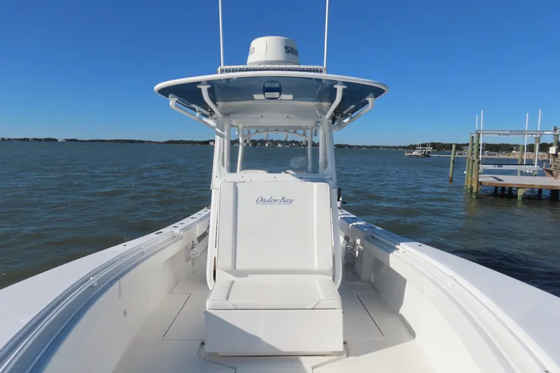 Slide: The Image of 2018 Onslow Bay 33 Tournament Edition boat on calm waters under clear blue sky. - 24