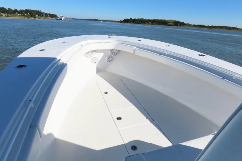 Slide: The Image of 2018 Onslow Bay 33 Tournament Edition boat on calm water, showcasing spacious deck. - 21
