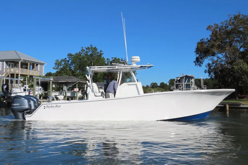 Slide: The Image of 2018 Onslow Bay 33 Tournament Edition boat on calm water near docks. - 5
