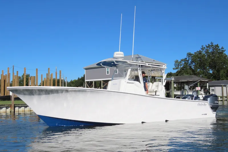 Slide: The Image of 2018 Onslow Bay 33 Tournament Edition boat on calm water, clear blue sky background. - 14