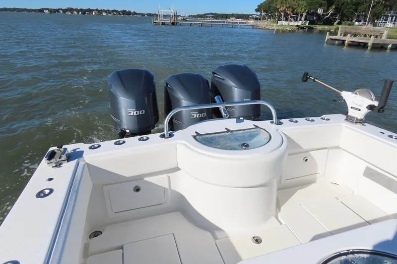 Slide: The Image of 2018 Onslow Bay 33 Tournament Edition boat with triple Yamaha 300 engines on water. - 23