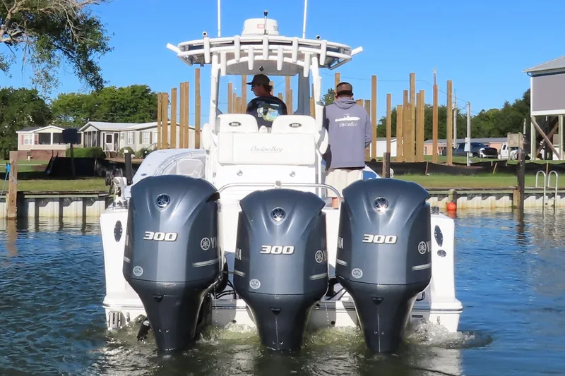 Slide: The Image of 2018 Onslow Bay 33 Tournament Edition boat with triple Yamaha 300 engines in water. - 1