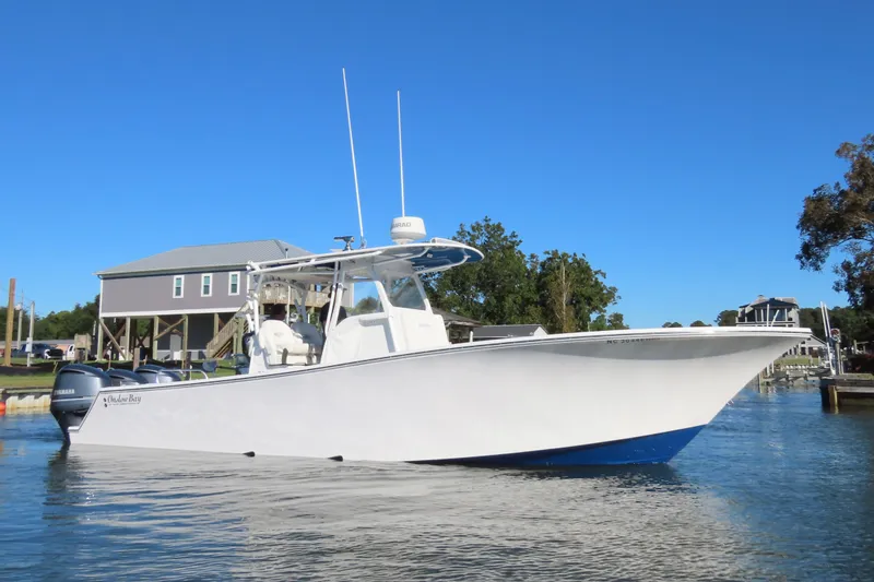 Slide: The Image of 2018 Onslow Bay 33 Tournament Edition boat on water, clear blue sky background. - 10