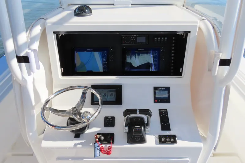 Slide: The Image of 2018 Onslow Bay 33 Tournament Edition boat console with steering wheel and navigation equipment. - 19