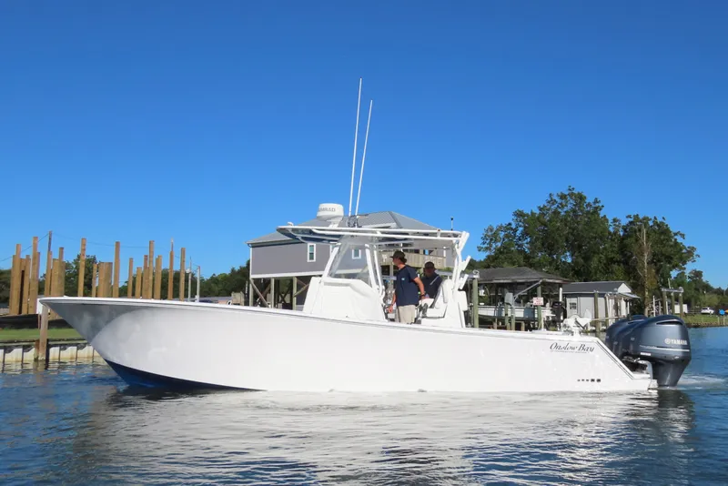 Slide: The Image of 2018 Onslow Bay 33 Tournament Edition boat on water, clear blue sky background. - 7