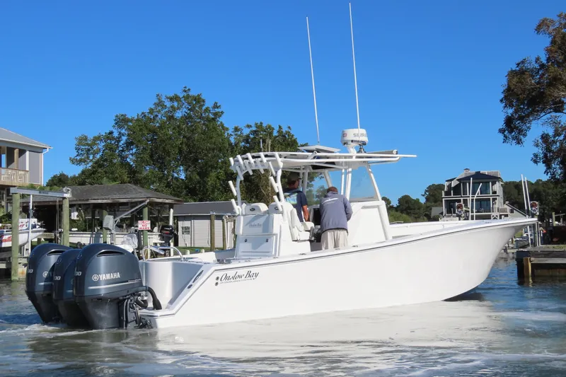 Slide: The Image of 2018 Onslow Bay 33 Tournament Edition boat with dual Yamaha engines on a sunny day. - 2
