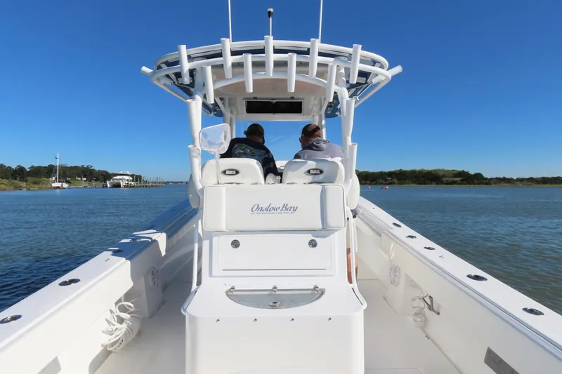 Slide: The Image of 2018 Onslow Bay 33 Tournament Edition boat cruising on a sunny day. - 22