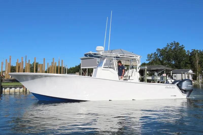 Slide: The Image of 2018 Onslow Bay 33 Tournament Edition boat on water, clear blue sky background. - 3