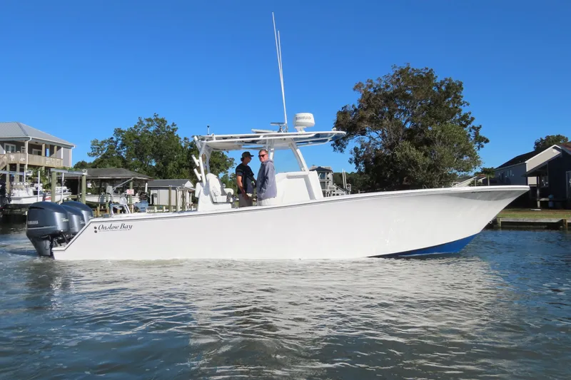 Slide: The Image of 2018 Onslow Bay 33 Tournament Edition boat on water, with two people onboard. - 15