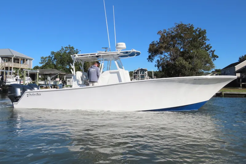 Slide: The Image of 2018 Onslow Bay 33 Tournament Edition boat on calm water, clear blue sky background. - 17