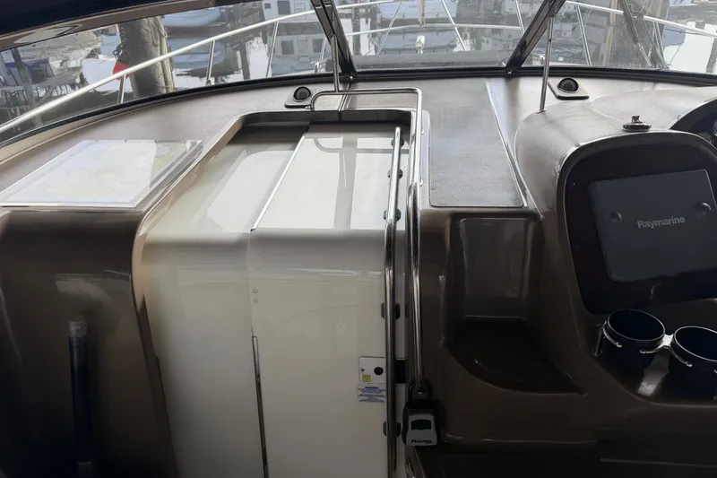 Slide: The Image of 2005 Regal Commodore 3560 cockpit with navigation equipment and sleek dashboard design. - 15